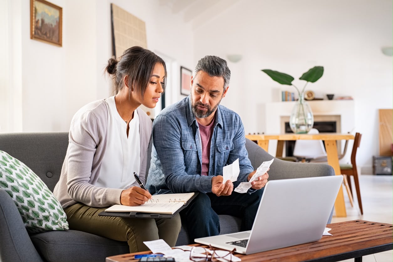 A couple reviewing their household energy bills together at home